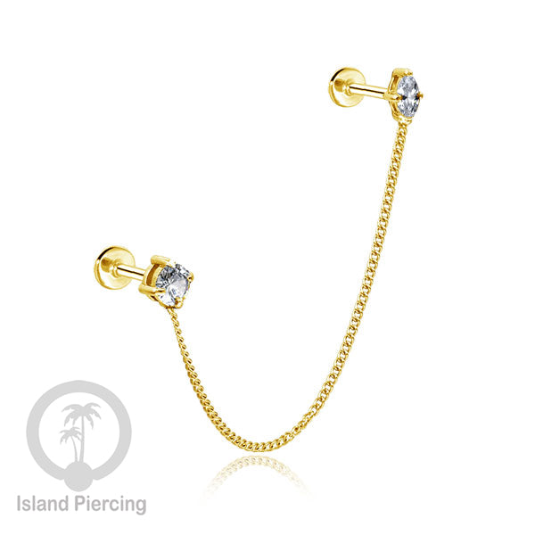 Piercing Set warna gold dengan dua Labret Kristal sambung dengan Rantai.