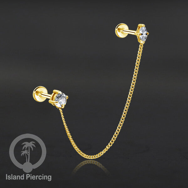 Piercing Set warna gold dengan dua Labret Kristal sambung dengan Rantai.