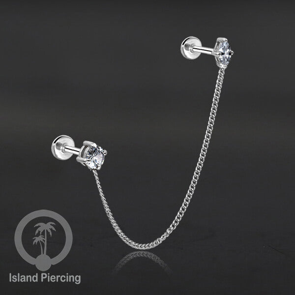 Piercing Set warna silver dengan dua Labret Kristal sambung dengan Rantai.