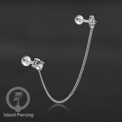 Piercing Set warna silver dengan dua Labret Kristal sambung dengan Rantai.