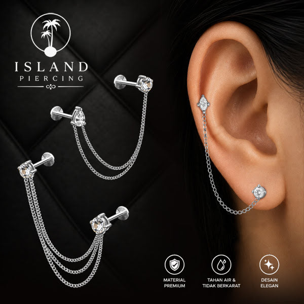 Piercing Set warna silver dengan dua Labret Kristal sambung dengan Rantai.
