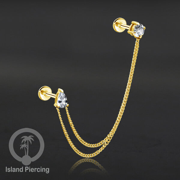 Piercing Set warna gold dengan dua Labret Kristal sambung dengan Rantai.