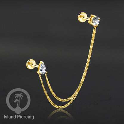 Piercing Set warna gold dengan dua Labret Kristal sambung dengan Rantai.