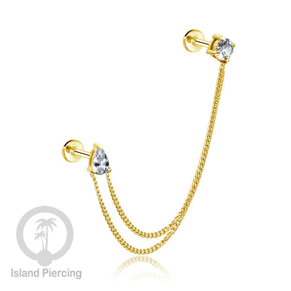 Piercing Set warna gold dengan dua Labret Kristal sambung dengan Rantai.