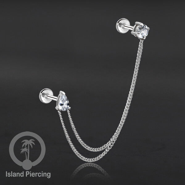 Piercing Set warna silver dengan dua Labret Kristal sambung dengan Rantai.