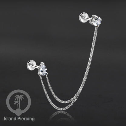 Piercing Set warna silver dengan dua Labret Kristal sambung dengan Rantai.