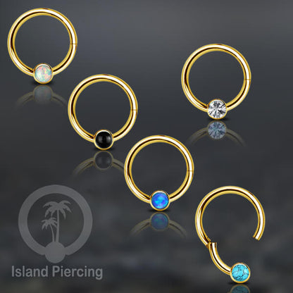 Hinged Segment Ring warna gold dengan batu di pakai dalam mulut bawah bibir atas.