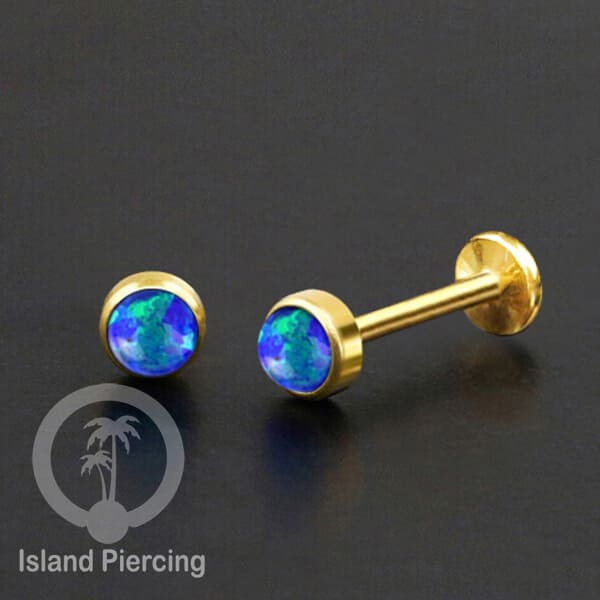 Tindik labret push system stainless, threadless piercing warna gold dengan abelone, opal putih dan biru.