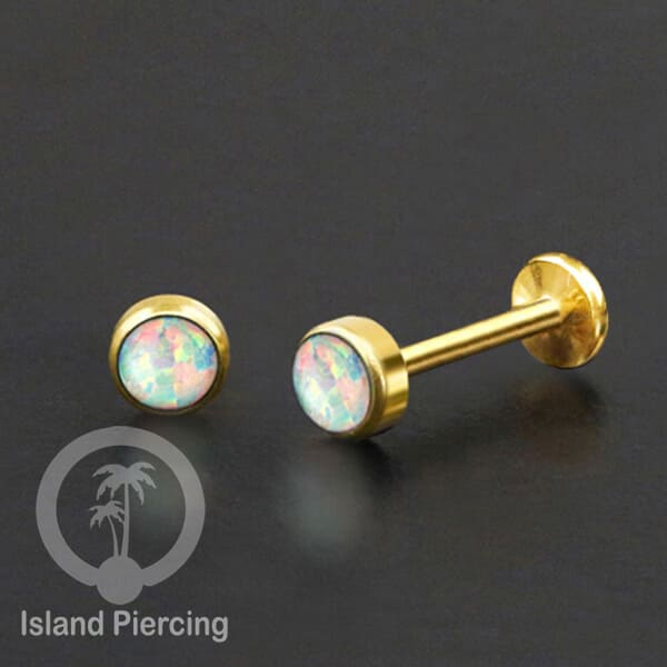 Tindik labret push system stainless, threadless piercing warna gold dengan abelone, opal putih dan biru.